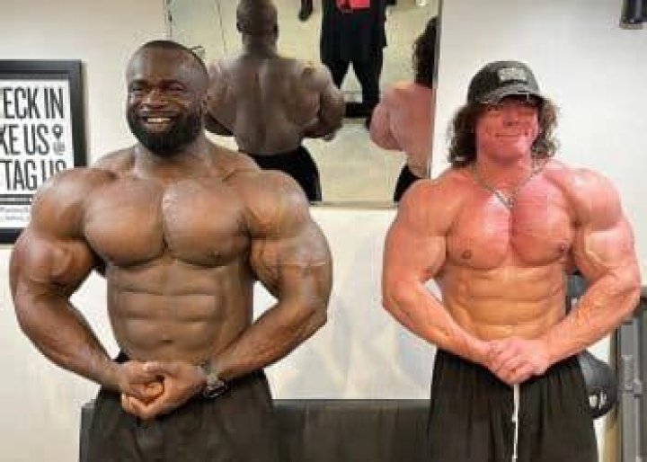 330lb Samson Dauda Towers Over Influencer Sam Sulek While Posing Side