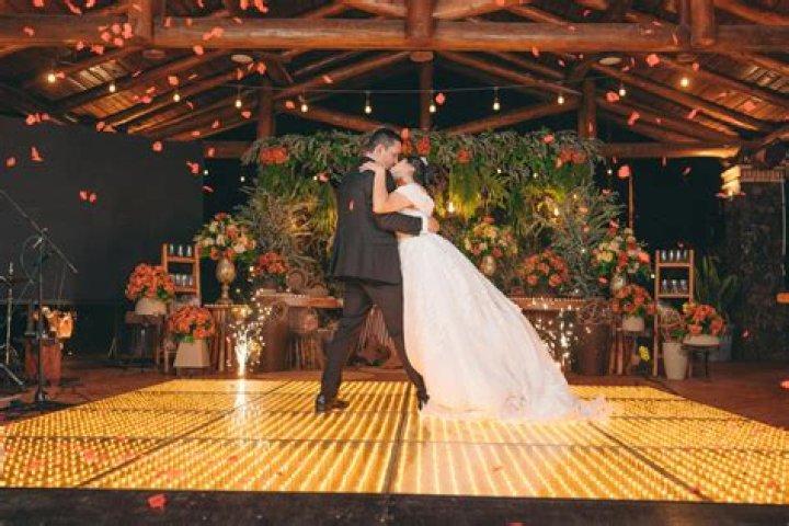 a bride and groom dance together at their wedding reception