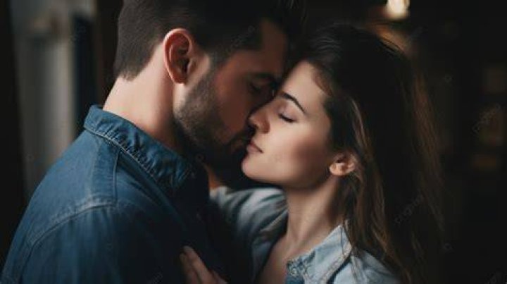 a man and woman kissing on the street