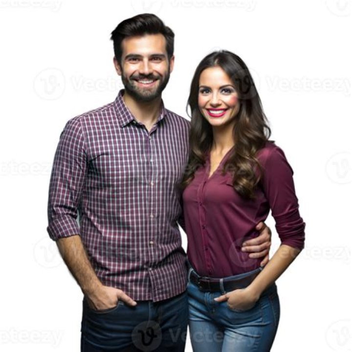 a man and woman standing on top of a mountain