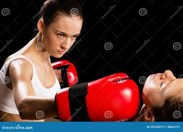 Aggressive Boxing Woman, Hits An Opponent In The Head Stock Photo