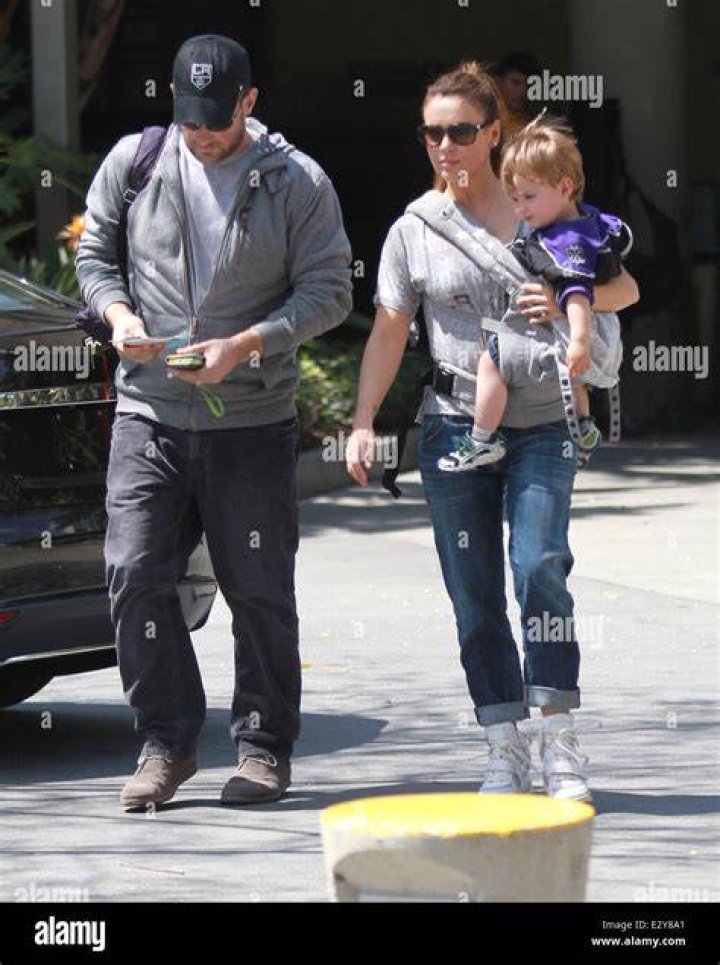 Alyssa Milano carries her son Milo Thomas as she leaves the Los Angeles