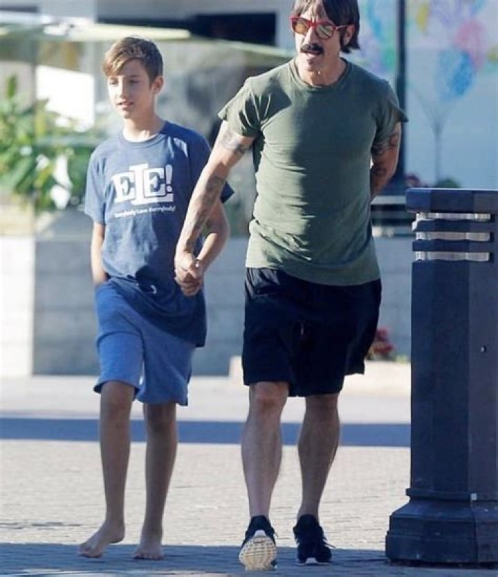 Anthony Kiedis greets son Everly Bear with a kiss while picking him up