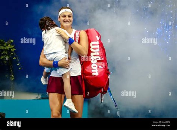 Aryna Sabalenka of Belarus holding her daughter arrives at the court