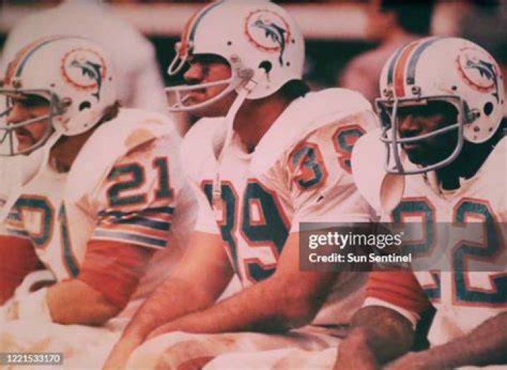 Dolphins Running Back Jim Kiick with wife Alice and baby Brandon. 1971
