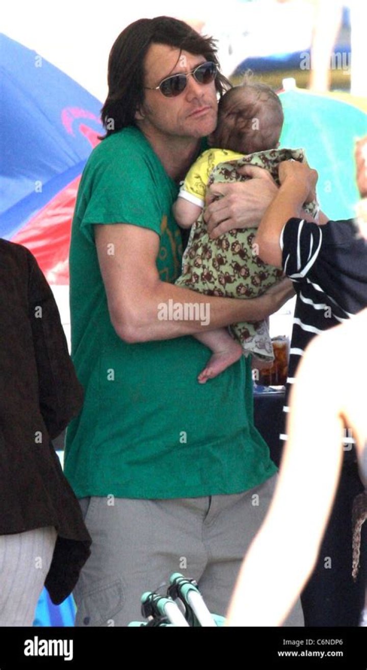 Jim holding his grandson jackson on malibu beach malibu hires stock