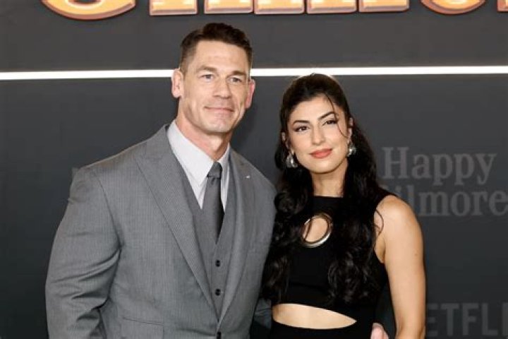John Cena embraces his wife Shay Shariatzadeh while leaving Vancouver
