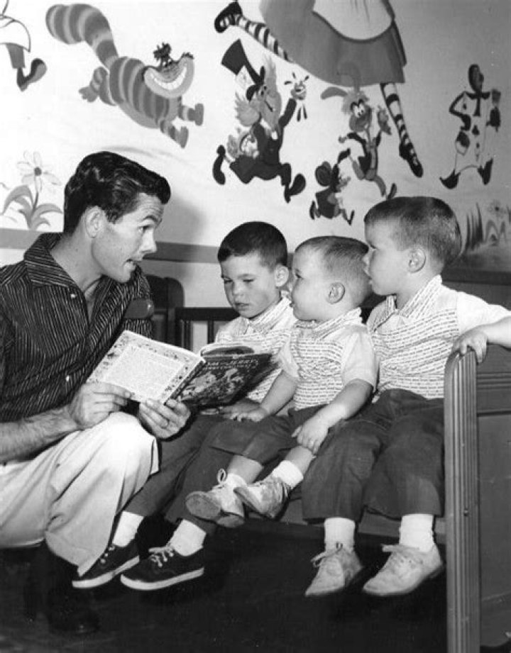 Johnny Carson reading a story to his three sons in 1955. From left
