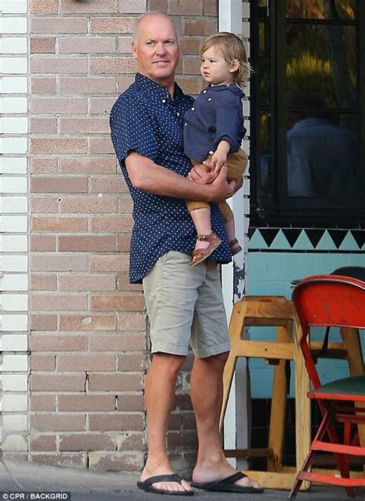 Michael Keaton plays doting grandpa as he cuddles up with adorable