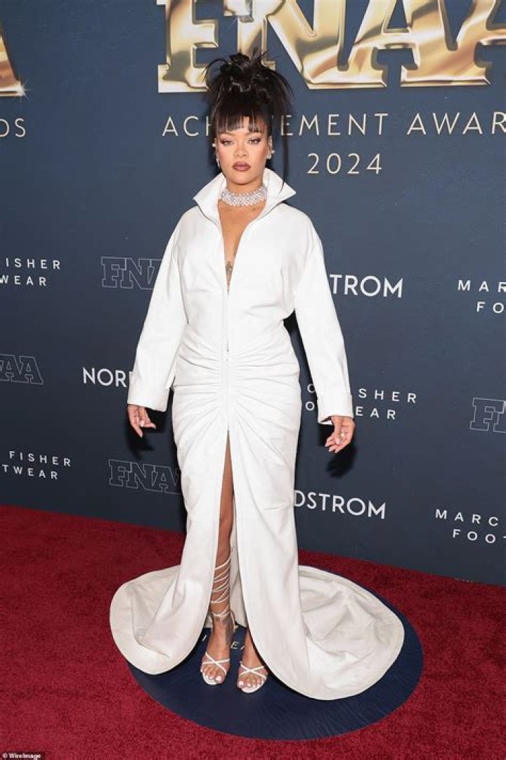Rihanna flashes cleavage in gown as she is joined by family at her