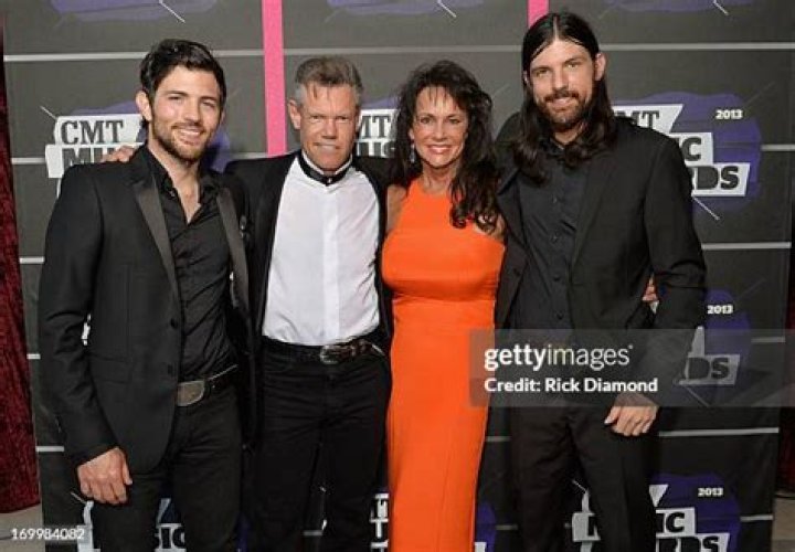 Scott Avett, Randy Travis, Mary Beougher and Seth Avett attend the