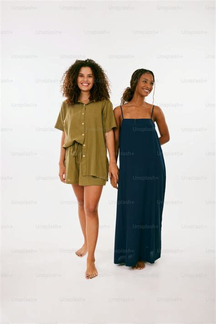 two women standing next to each other in front of a crowd on the